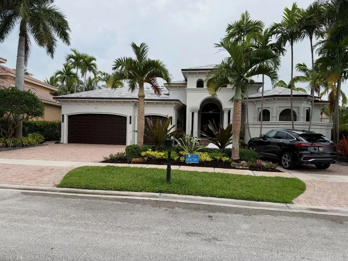 Street view of a home with its roof sealed in white underlayment and a Glades Edge Roofing sign in the yard